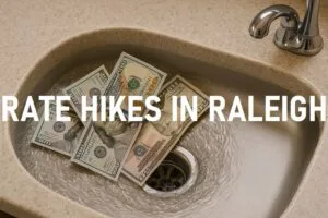 U.S. dollar bills swirling down a kitchen sink drain, symbolizing rising utility costs in Raleigh