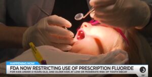 Child receiving dental examination as FDA restricts prescription fluoride use